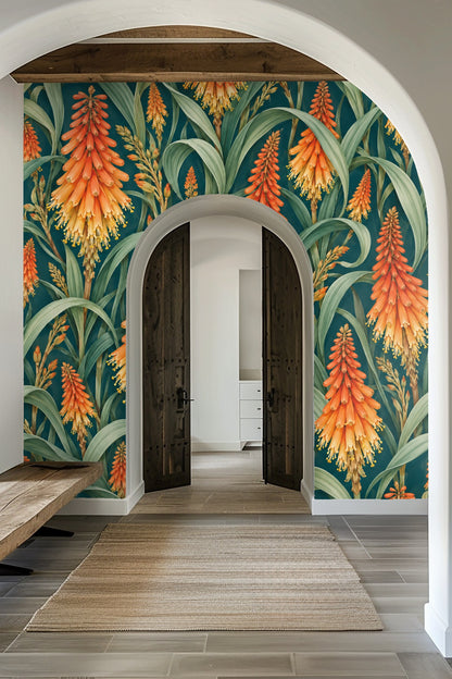 Close-up of botanical wallpaper artwork with orange and yellow kniphofia flowers and green leaves on a deep teal background