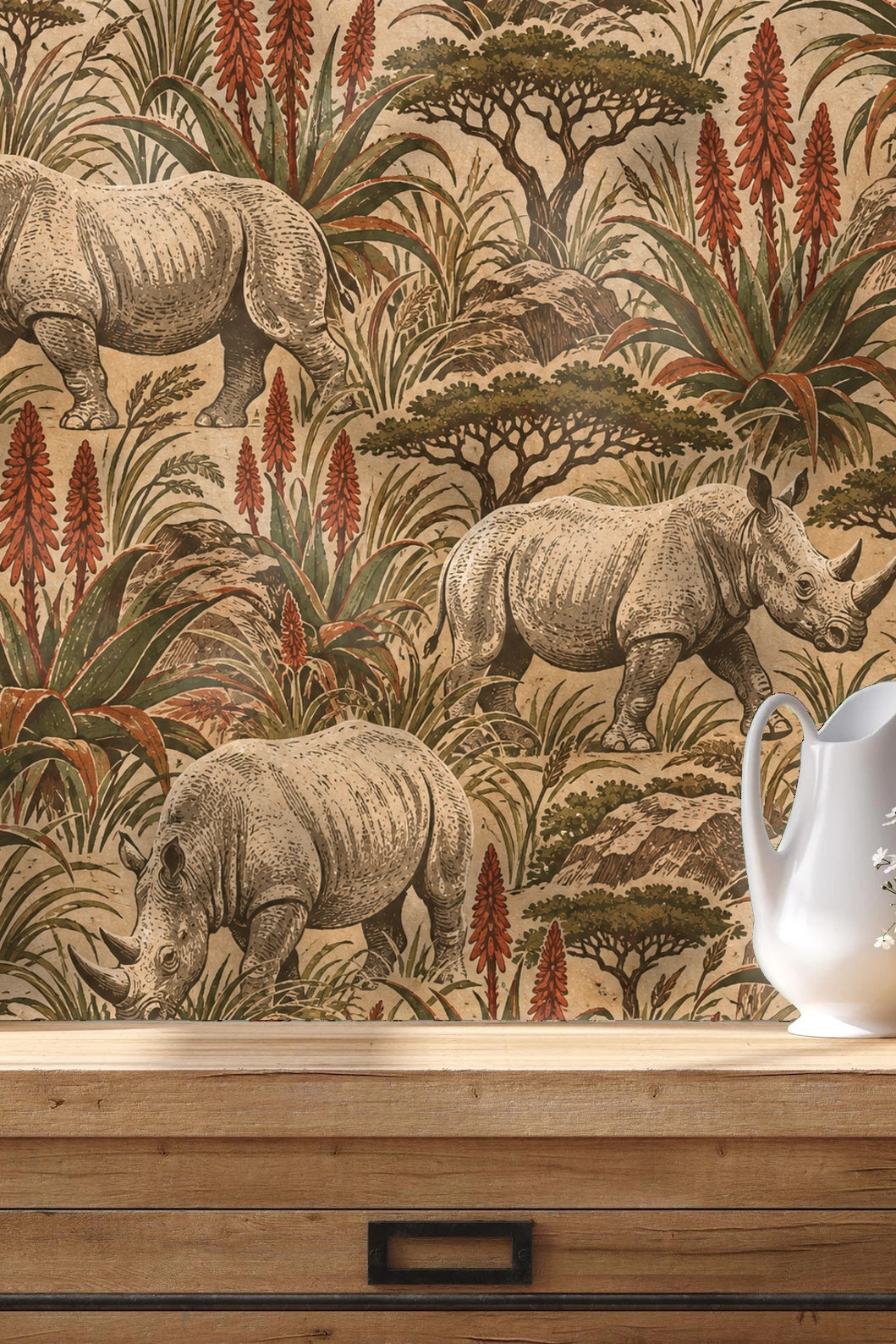Living room vignette with beige armchair and botanical wallpaper with rhinos and aloe plants