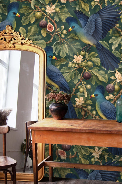 Side view of a wallpapered wall in a room with modern brass wire chairs, focusing on a flying Turaco bird amid fig leaves.