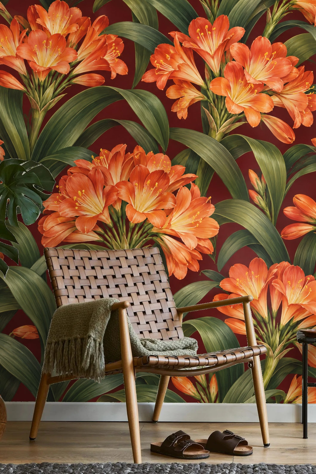 Decor detail of vase placed before bright clivia wallpaper wall in warm burgundy tones