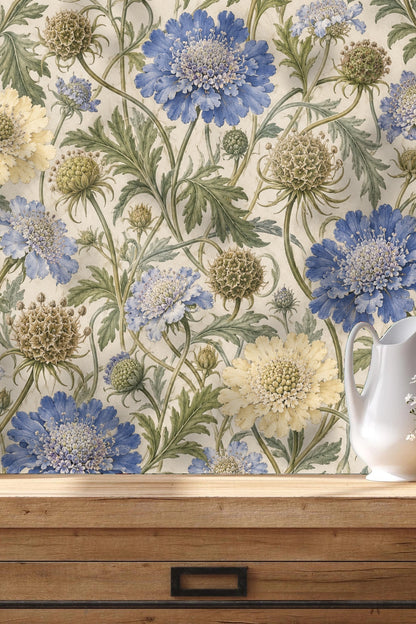 Interior view of a living room wall decorated with the botanical scabious seed wallpaper showing scale and atmosphere