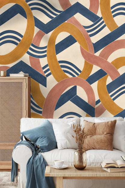 Decorative vignette featuring houseplant and books with Amber Orbit Weft wallpaper
