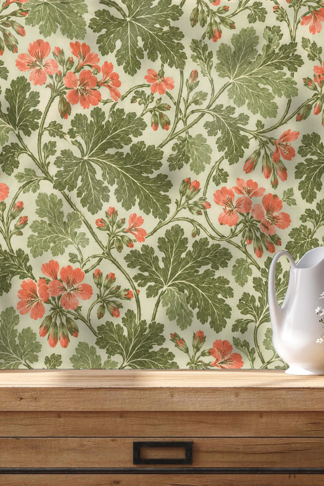 Detail of overlapping green leaves with fine vein lines and coral flowers on wallpaper