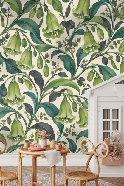Living room corner showing wallpaper with green bell flowers behind gray sofa with cushions