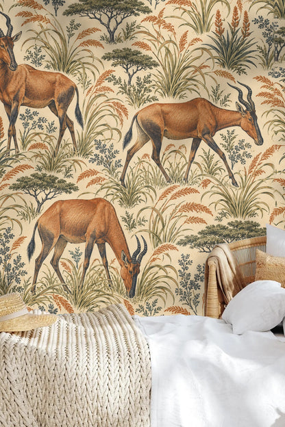 Living room corner with Hartebeest Grove wallpaper showing antelope and foliage motifs behind neutral furniture
