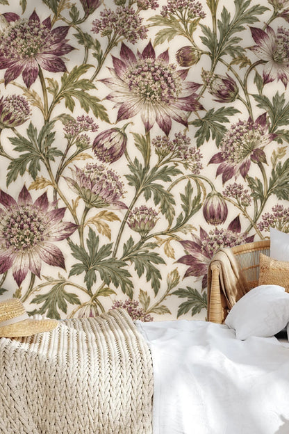 Child's playroom corner featuring rattan furniture and astrantia floral wallpaper backdrop.