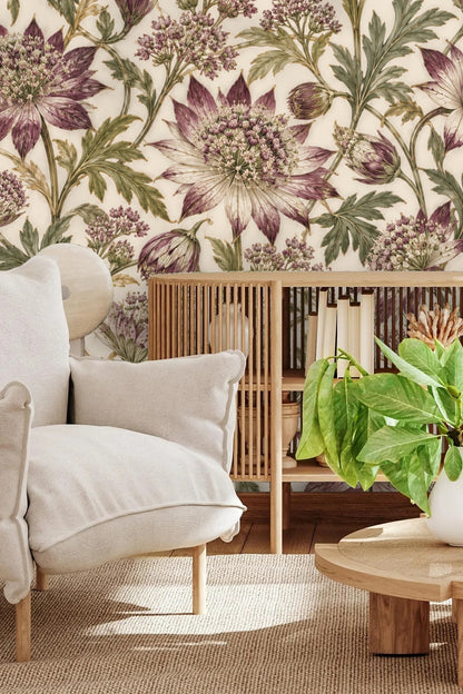Living room corner with cream chair and wooden console against astrantia floral wallpaper.