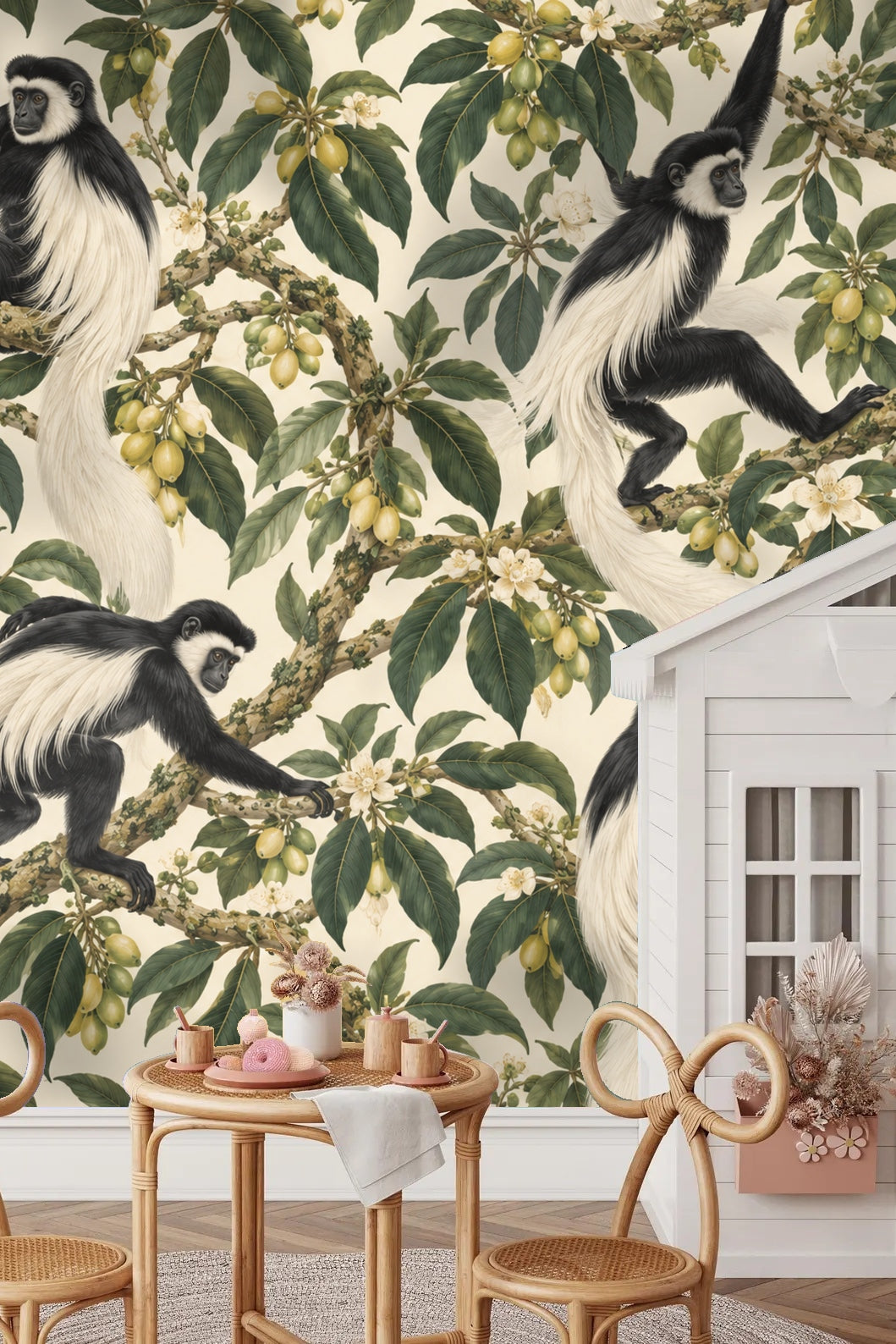 Living room featuring Colobus Tassel Canopy wallpaper behind a beige corduroy sofa and rattan cabinet.