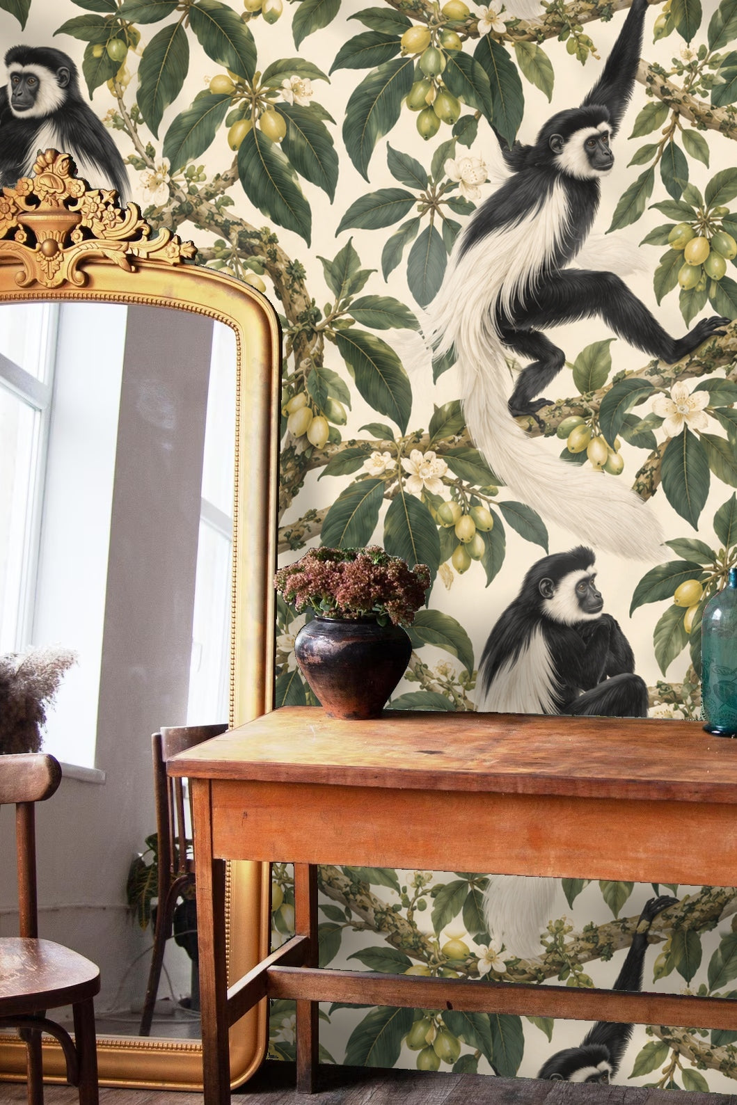 Full wall coverage of wallpaper showing thick twisting branches, leaves, and black and white monkeys.