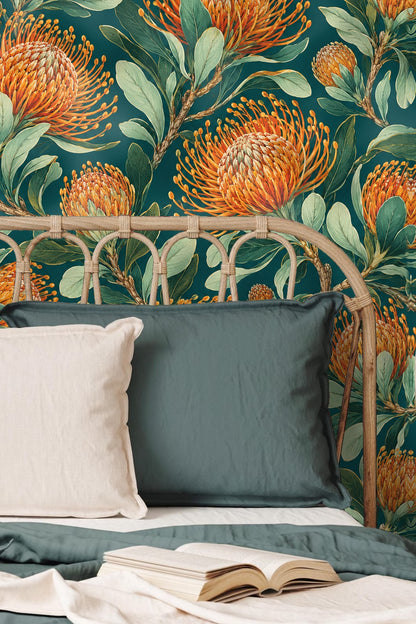 Playroom wall with bold pinncushion protea botanical wallpaper in orange and green accents with children’s furniture in front.