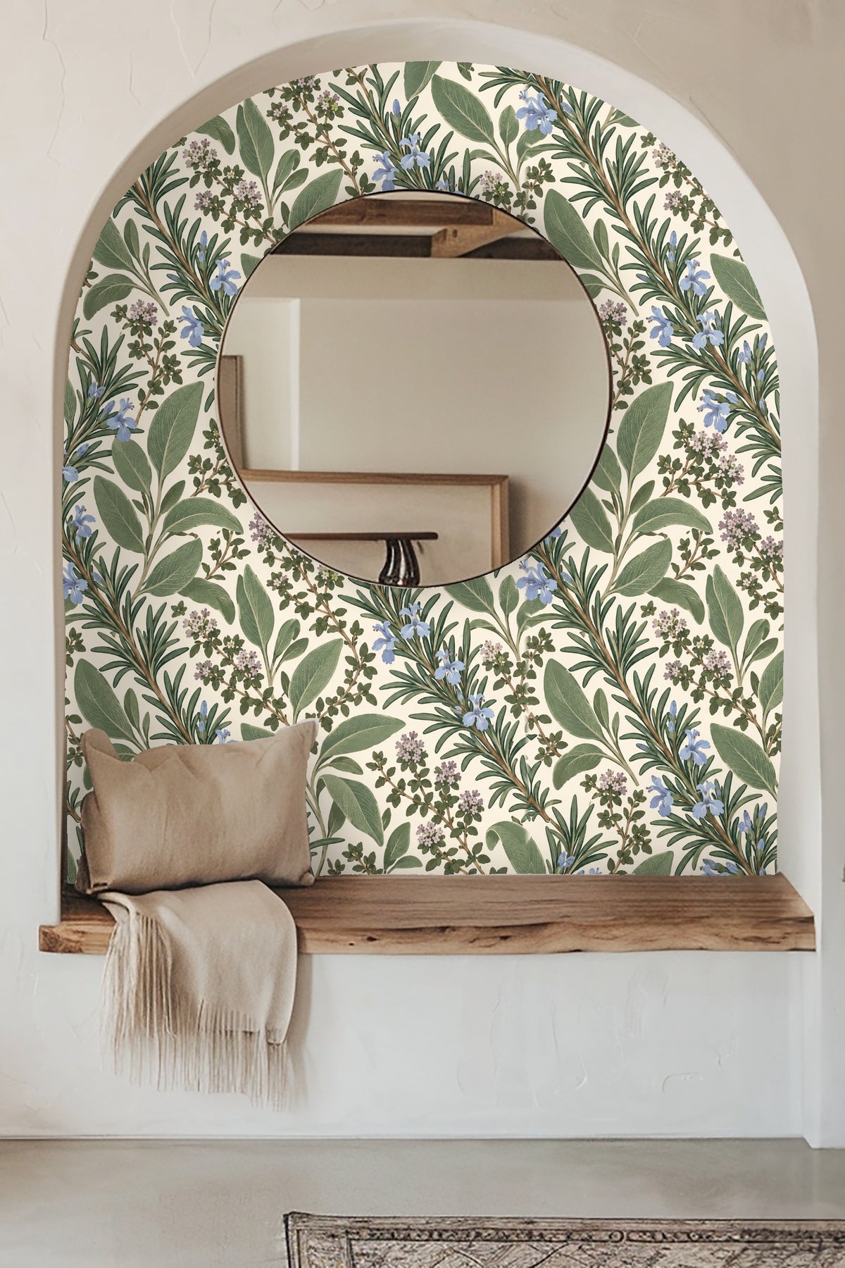 Living room wall dressed in Herb Garden Sprigs wallpaper behind blue velvet mid-century couch