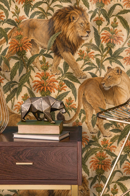 Male lion in profile walking through a garden of orange leonotis on wallpaper
