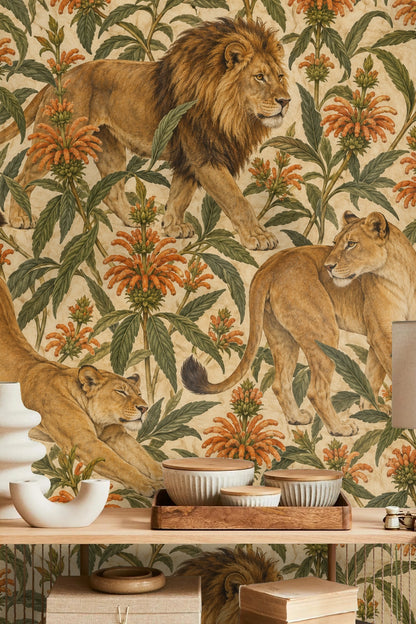 Two lionesses interspersed among tall green leaves and orange flowers