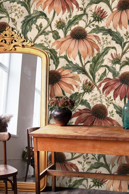 Cream-colored couch in front of detailed rust and green floral wallpaper.