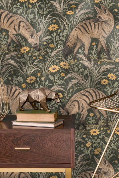Hand holding aardwolf wallpaper sample with cup and dried leaves nearby