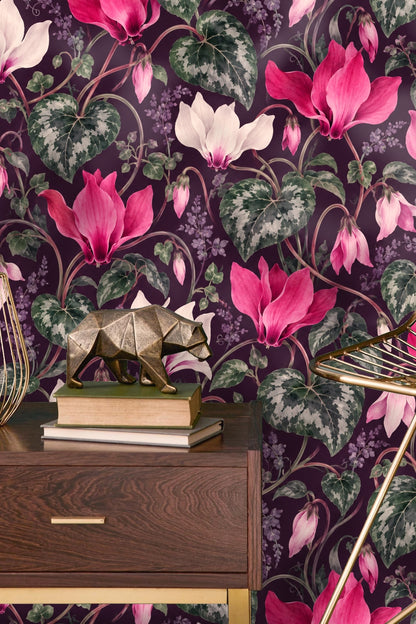 Boho-style lounge with orange sofa and cyclamen wallpaper dominating the background