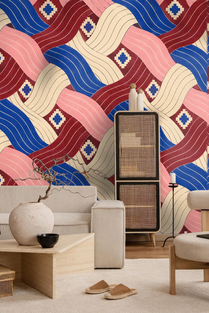 Cozy sitting area featuring wallpaper with dynamic pleated ribbons in blue, pink, cream, and maroon hues