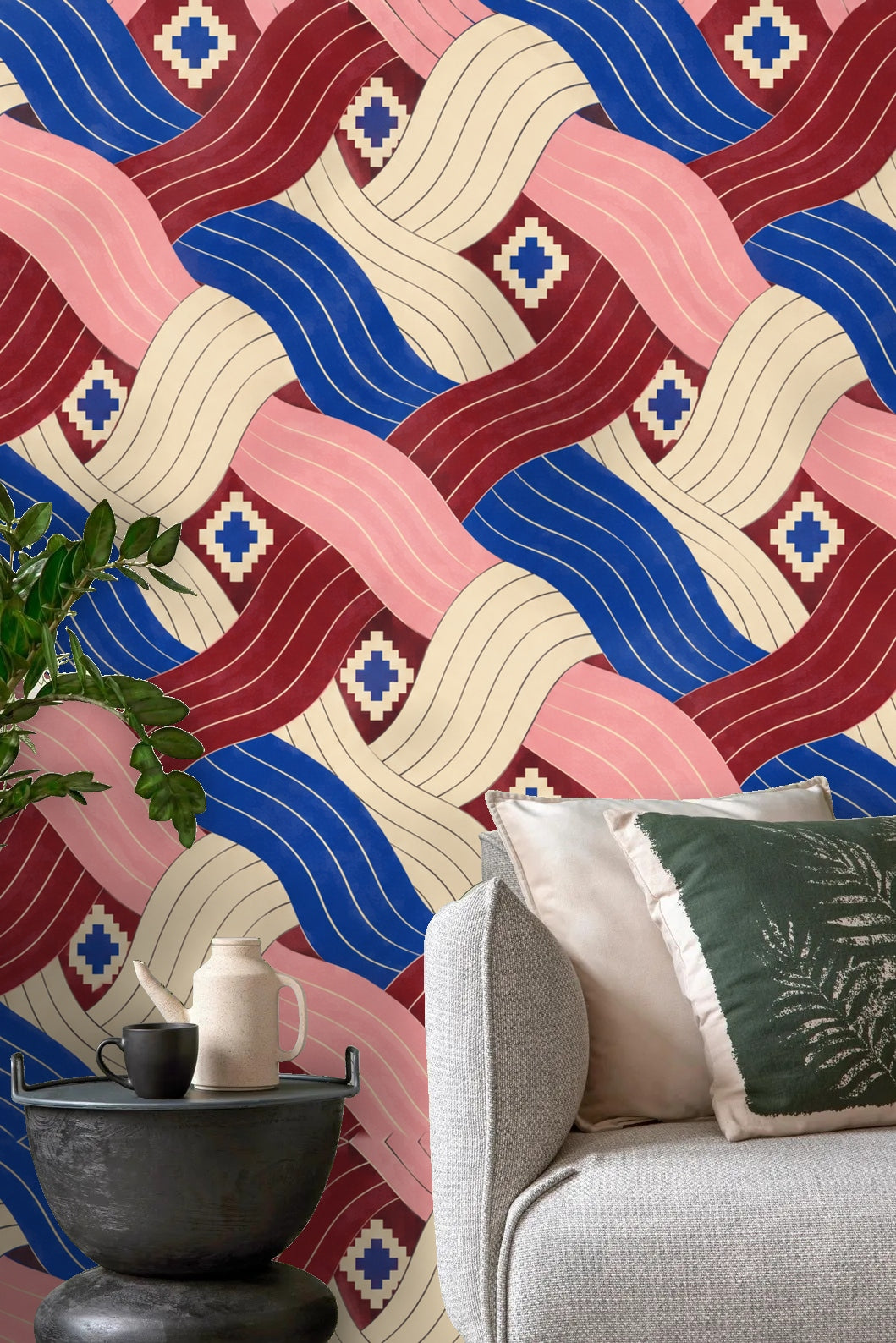 Geometric wallpaper with interlacing pleated ribbons in cobalt blue, dusty rose, cream, and maroon
