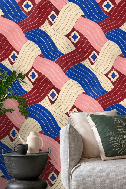 Geometric wallpaper with interlacing pleated ribbons in cobalt blue, dusty rose, cream, and maroon