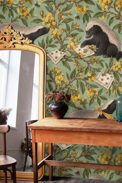 Brown wooden sideboard with a white pitcher in front of the honey badger honeybush wallpaper