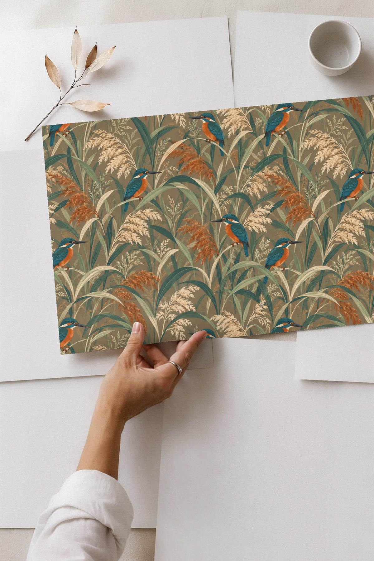 Intricate botanical brushwork of grasses and small reed flower spikes with perched birds across wallpaper.