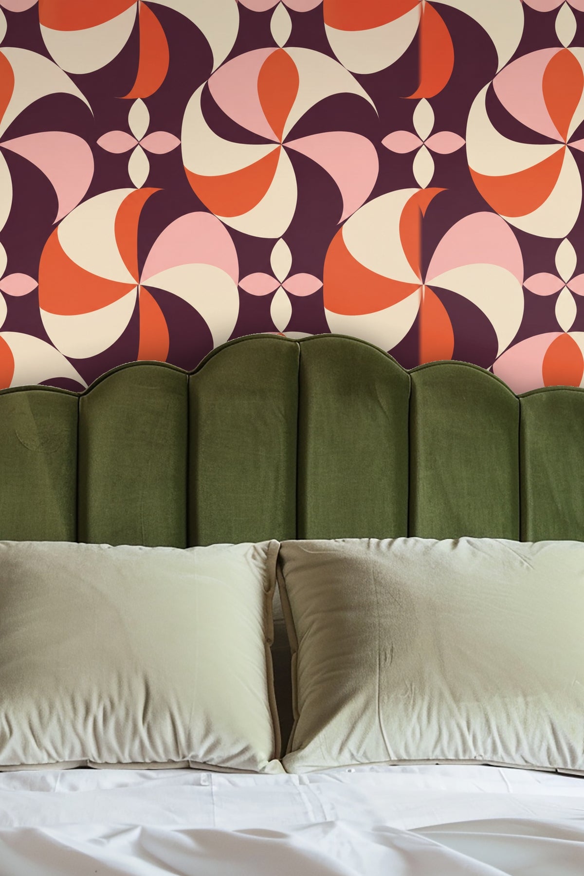 Entryway niche with arched wall covered in Plum Pinwheel wallpaper behind round mirror and wooden bench