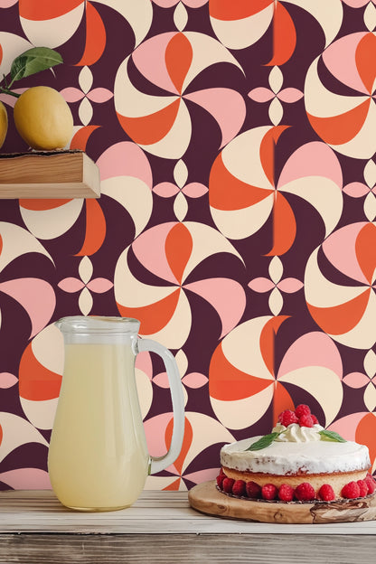 Interior shot showing the contrast of Plum Pinwheel wallpaper with neutral textiles