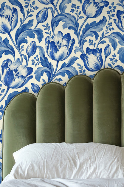 Wallpaper pattern detail showing large blue tulips and leaves painted in brush strokes on a white background