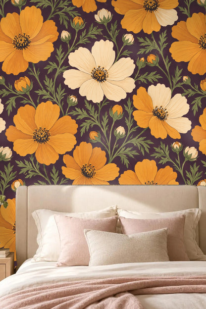 Amber Cosmos Bloom wallpaper behind a candle and glass vase with baby's breath flowers on a light wood surface