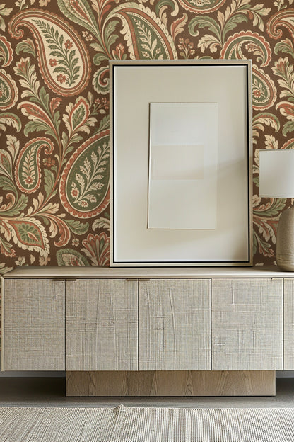 Bedroom scene with the Tobacco Paisley Reverie wallpaper covering an accent wall behind a light wood bed and neutral bedding, framed by two,