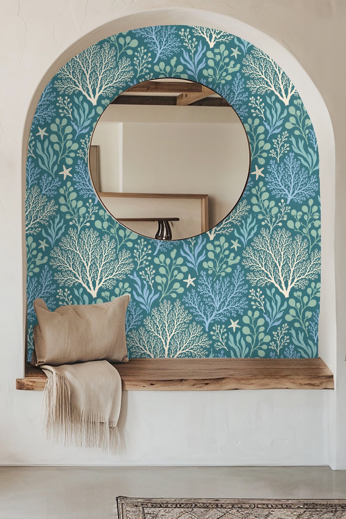 Bedroom with green upholstered headboard against wallpaper depicting coral and seaweed motifs