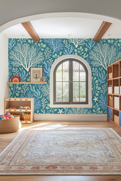 Varied seaweed fronds painted in blue and green on wallpaper