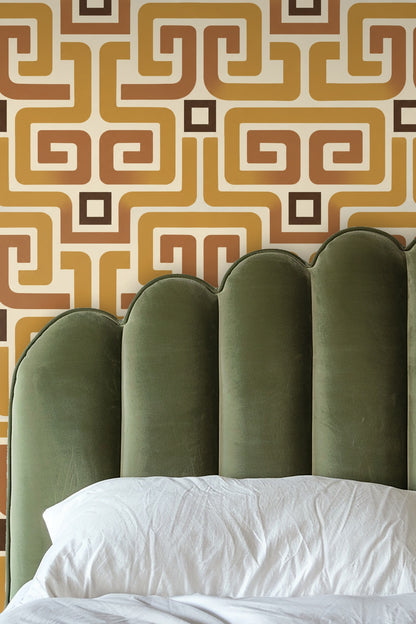 Ochre Meander wallpaper in living room with round wooden side table and neutral sofa