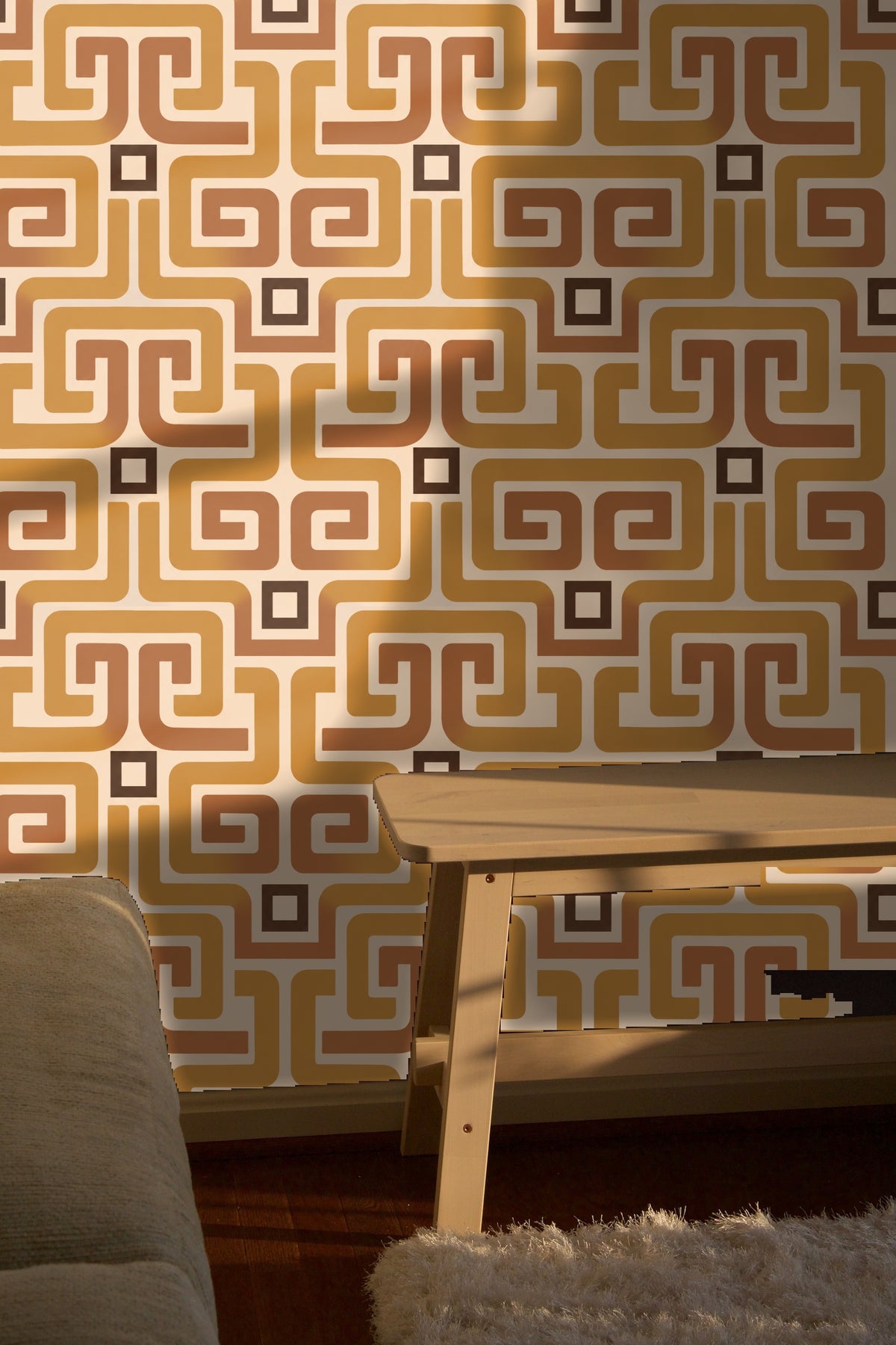 Bedroom interior with ochre meander wallpaper behind plush green headboard