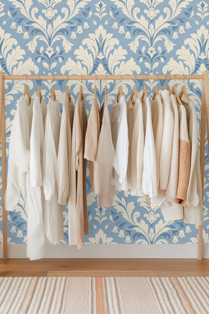 Abstract view of detailed damask pattern showing creamy foliage on soft blue background.