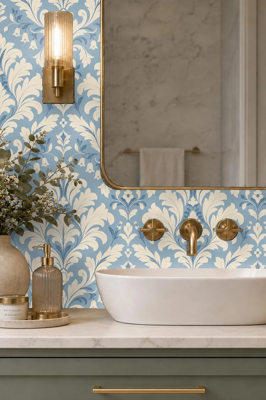 Room corner with damask wallpaper reflecting soft natural light through a mirror.