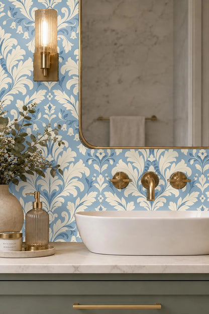 Room corner with damask wallpaper reflecting soft natural light through a mirror.
