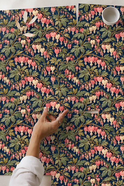 Living room with coral pendant dicentra floral wallpaper and blush velvet chair