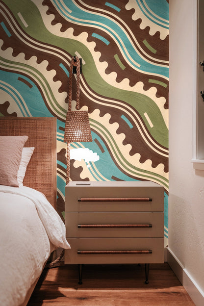 Close-up of Crenellation Current wallpaper pattern showing wavy lines in blue, brown, and green with crenellated edges