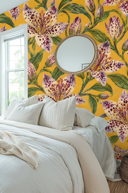 Living room corner with leather chair and Tricyrtis Speckled Rhapsody wallpaper featuring large spotted lilies on golden yellow backdrop