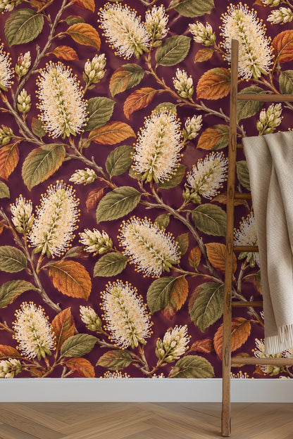 Detailed wallpaper artwork showing ivory bottlebrush flowers and green and rust leaves on a deep plum background