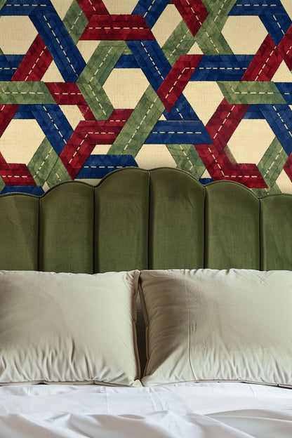 Detail of geometric braid pattern interwoven in blue, red, and green on linen base