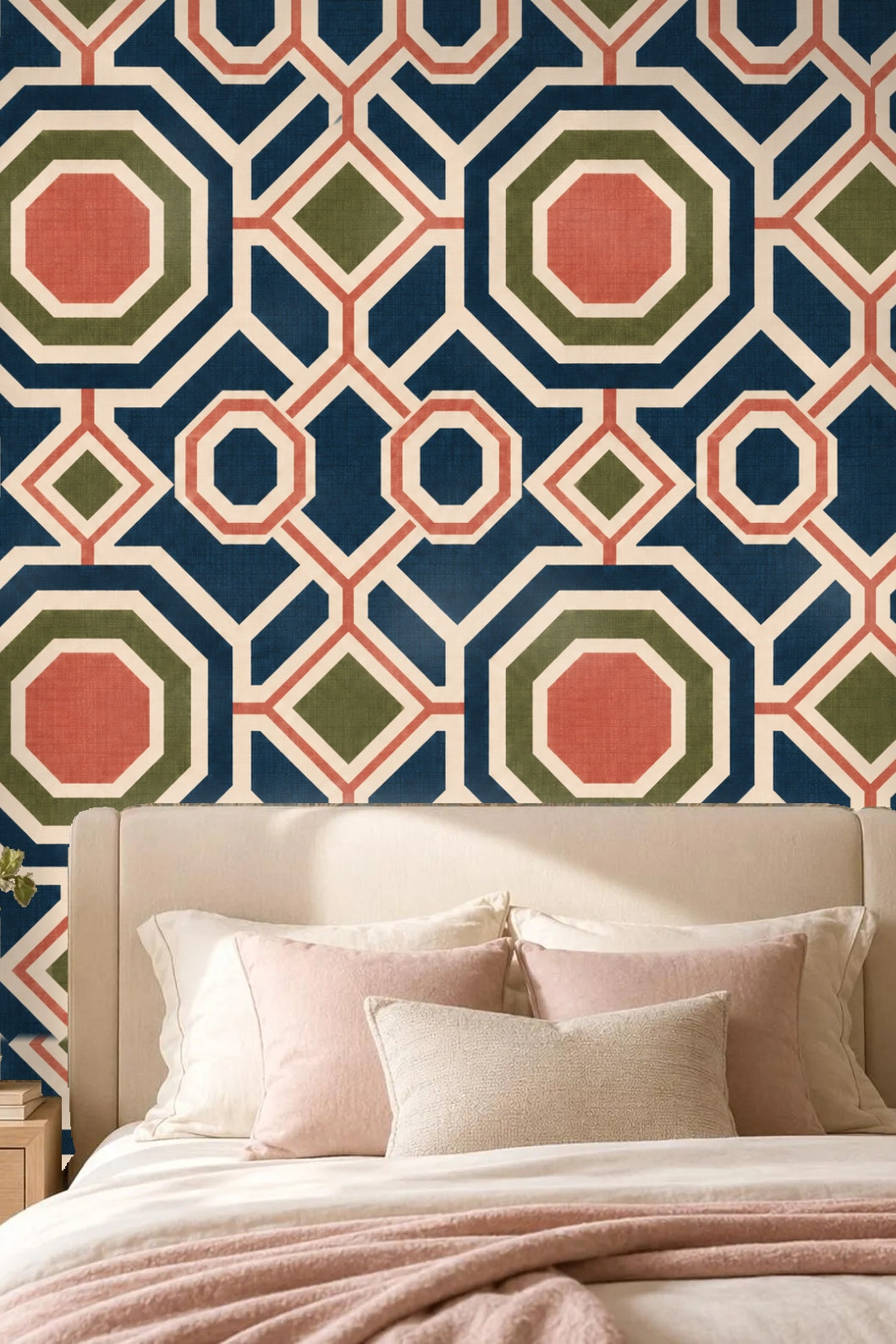 Entryway with curved arch showing wallpaper with large blue and coral octagonal geometric design behind a round mirror and wood bench.