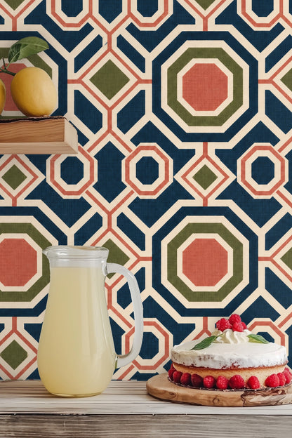 Wall with wallpaper showing large octagonal shapes in blue and coral with olive diamond points through a cozy interior.