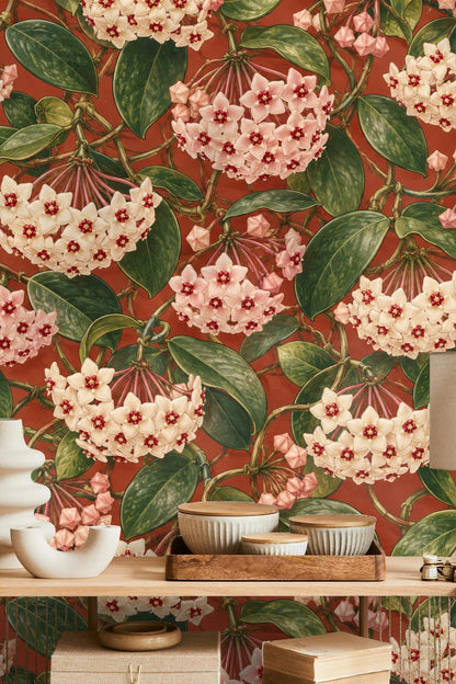 Section of wallpaper showing dense green leaves and twisting stems