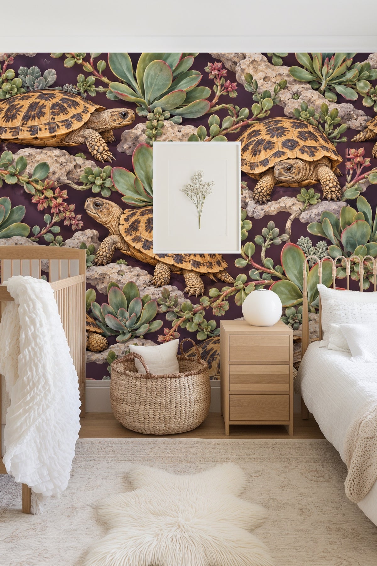 Living room scene with blush chair against wallpaper of pancake tortoises and succulents on dark plum background.
