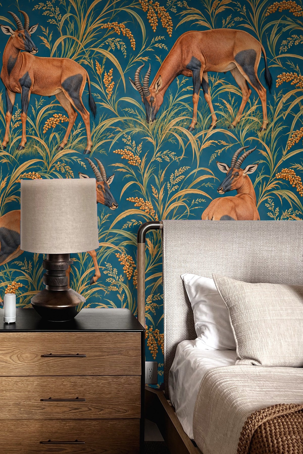 Room shot showing Topi in Petrol Fields wallpaper behind a cream curved sofa and modern decor