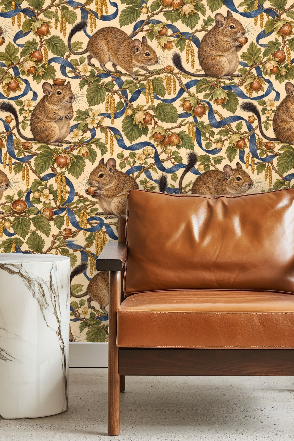 Entryway alcove wallpapered with degu and hazelnut branch pattern behind round mirror and wood bench