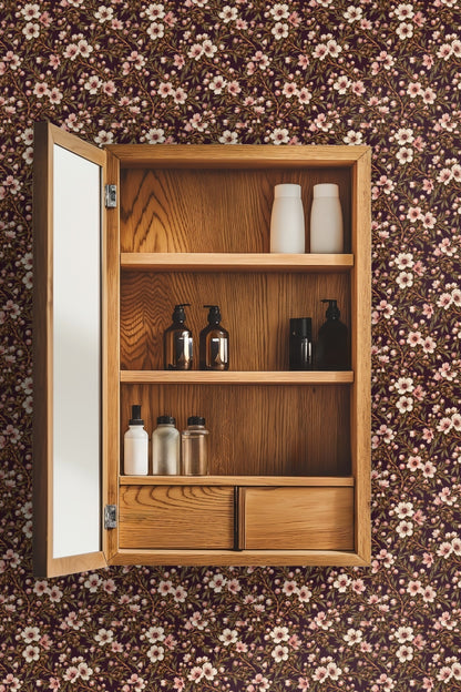 Cozy niche with a round mirror above a bench framed by leptospermum floral wallpaper