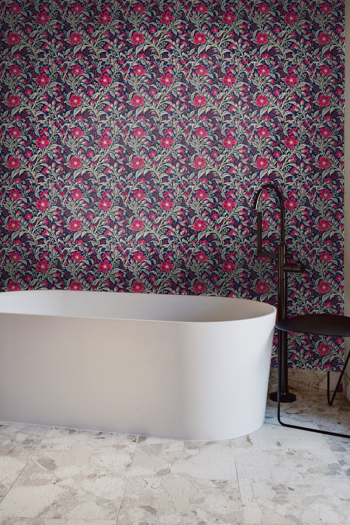 Bright crimson flower and silver buds on dark blue wallpaper close-up